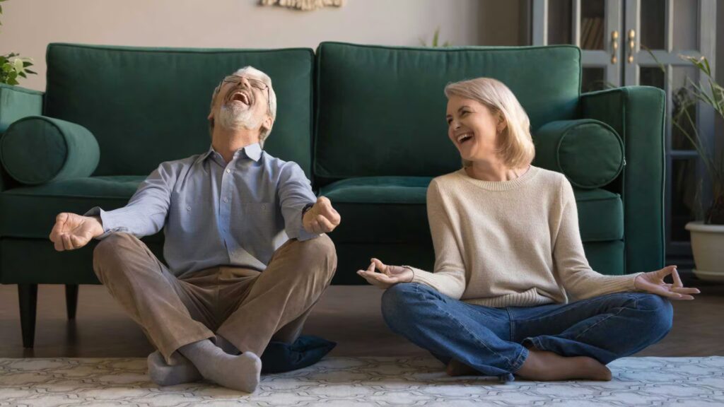 Couple doing yoga at home small